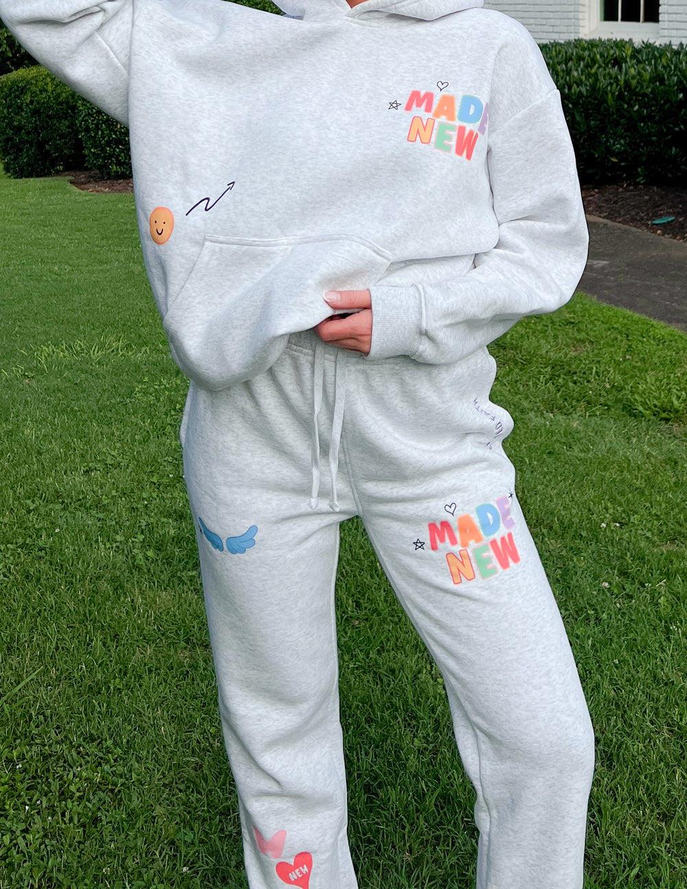 Light gray unisex sweatpants with drawstring, front pocket, and colorful MAD NEW prints
