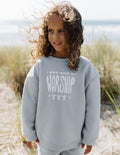 Kids crewneck sweatshirt, light blue; chest “worship” graphic, crew neckline