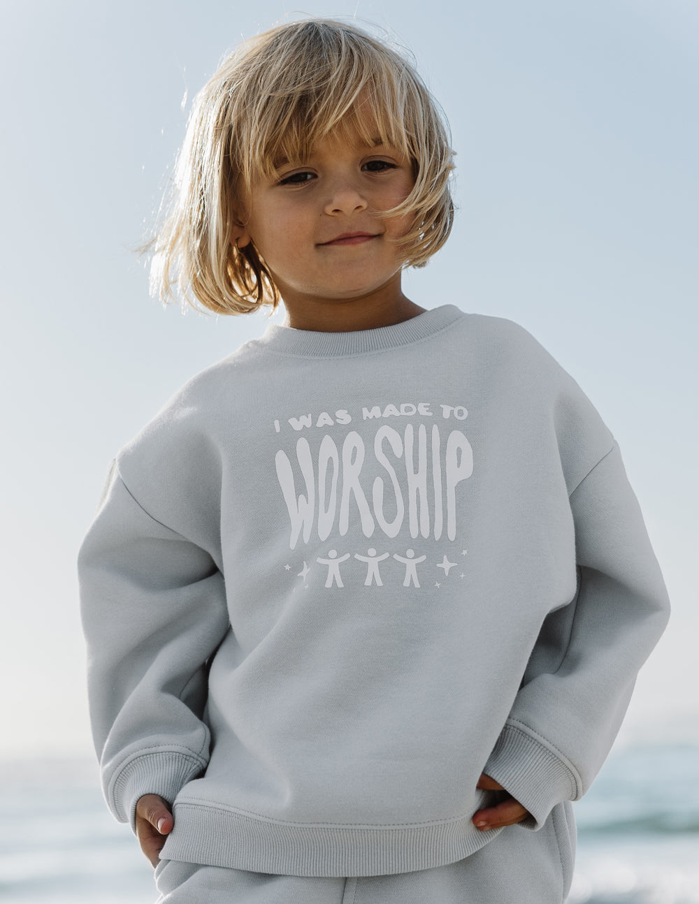 Kids crewneck sweatshirt, light blue with “worship” graphic on front