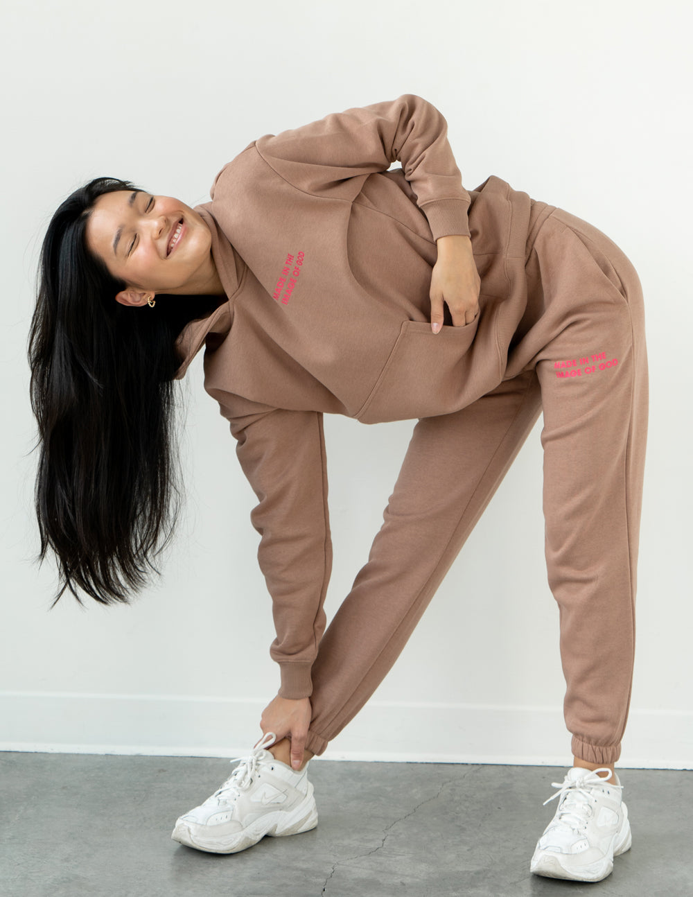 Brown unisex sweatpants, jogger fit with elastic cuffs and red side logo print