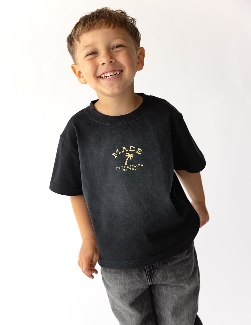 Kids black graphic tee with gold 'MADE' text print on the front