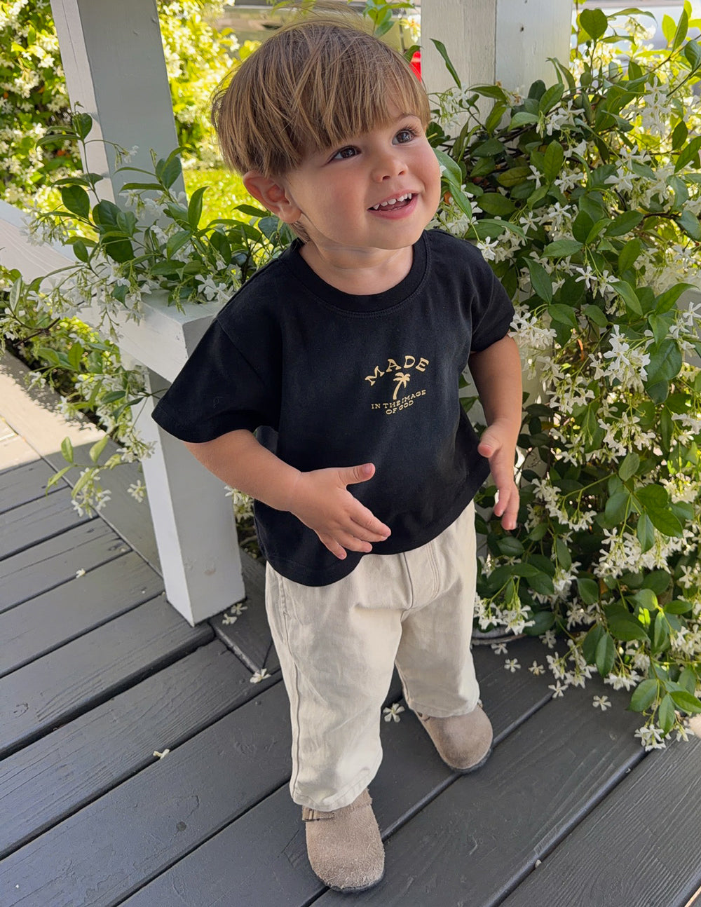 Kids black graphic tee with gold chest logo and crew neckline