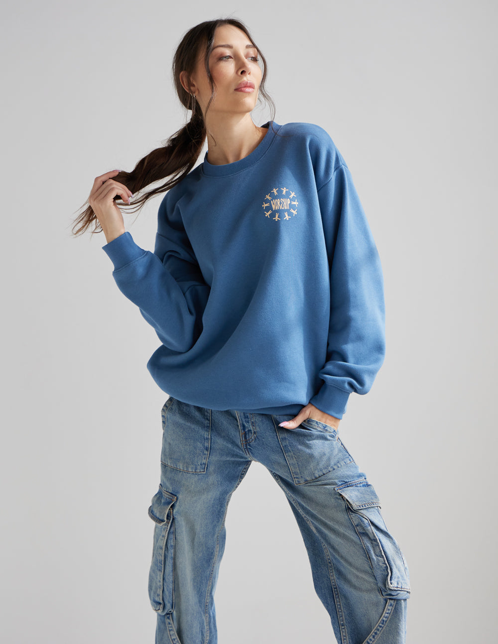 Blue unisex crewneck sweatshirt with small worship graphic at chest