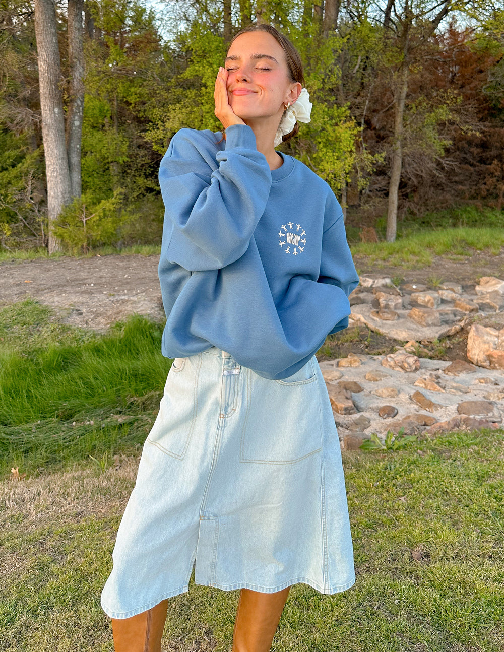 Blue unisex crewneck sweatshirt with small worship graphic at chest