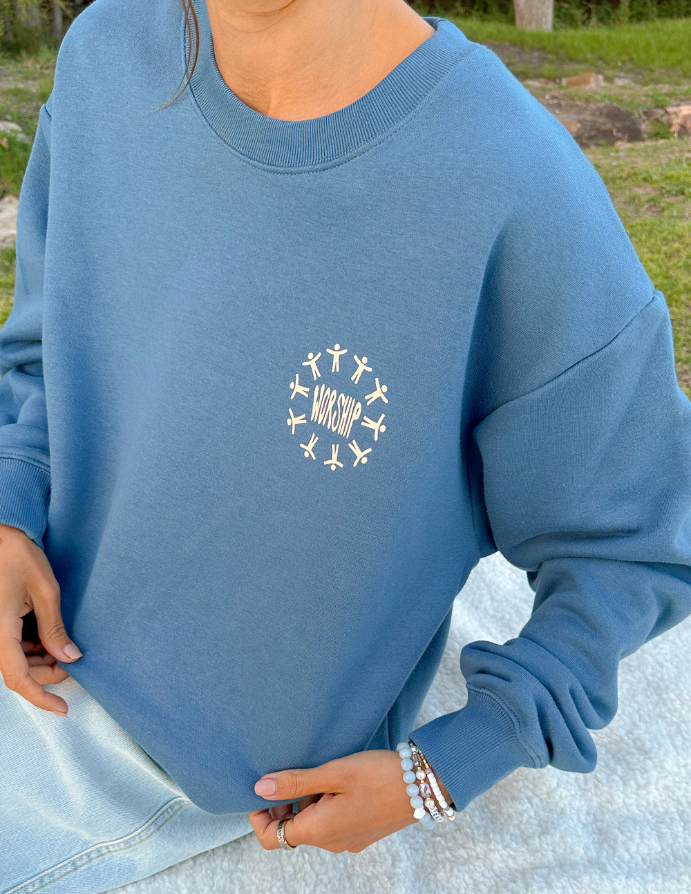 Blue unisex crewneck sweatshirt with small worship graphic on chest