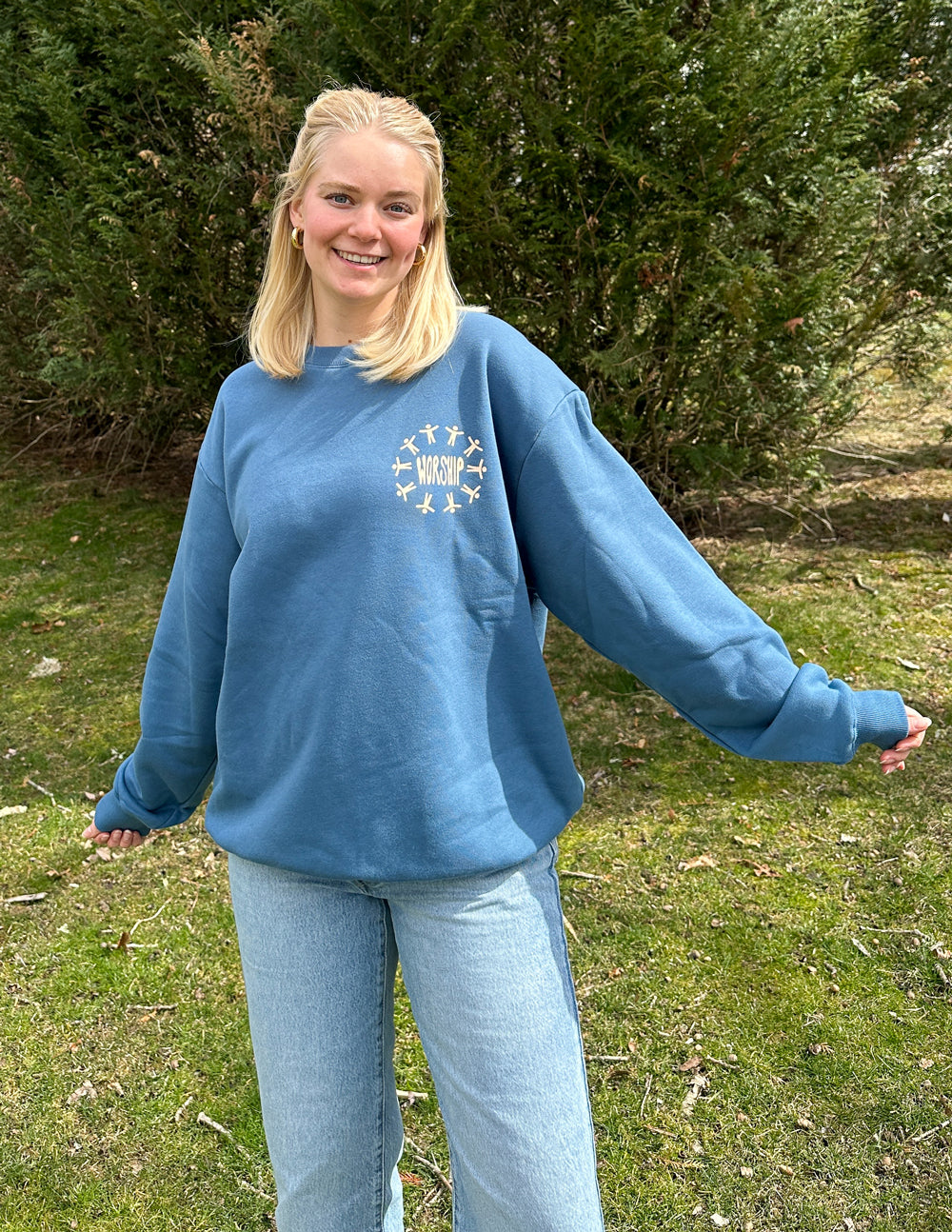 Blue unisex crewneck sweatshirt with small worship graphic on chest