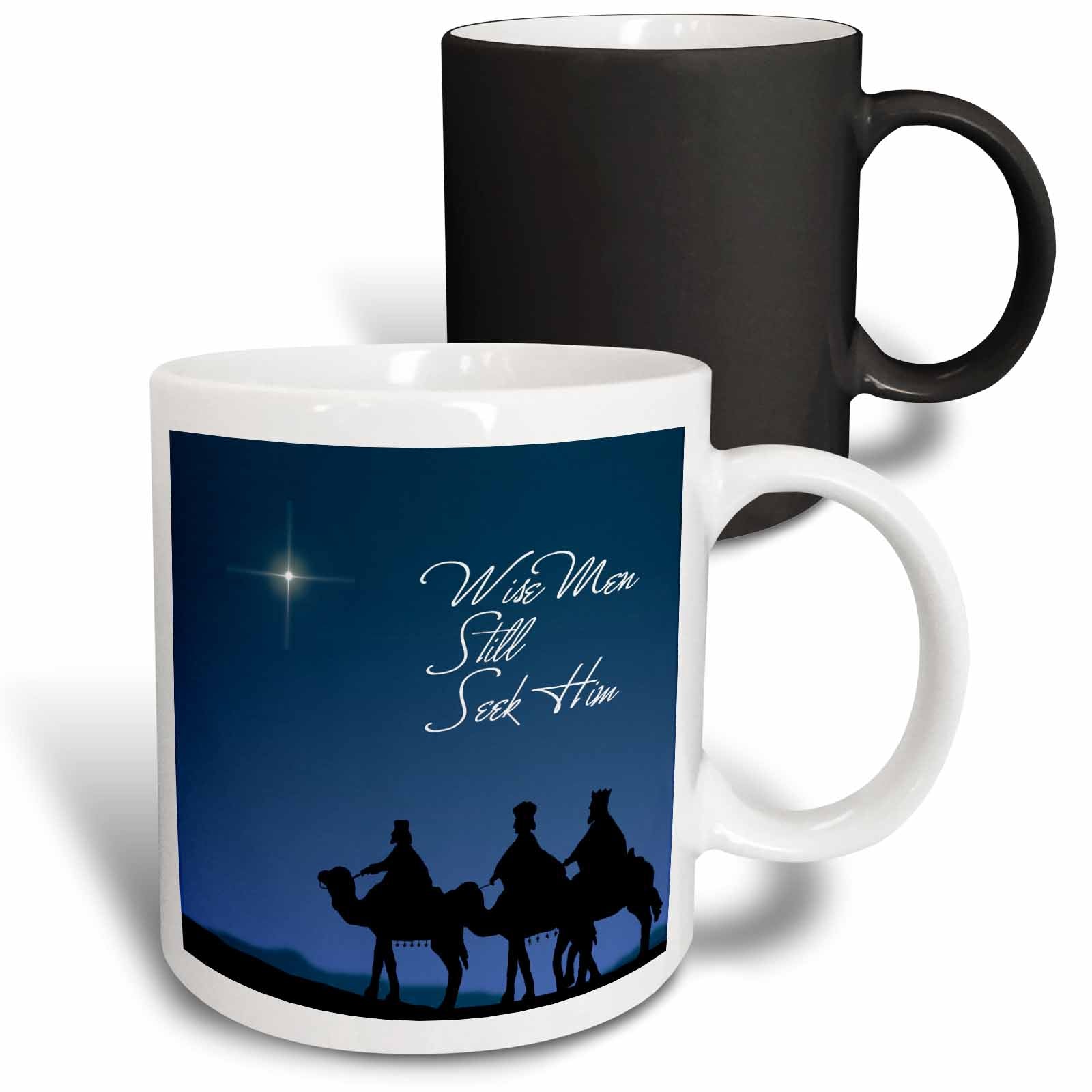 Two mugs stacked: white mug with blue nativity and black mug behind