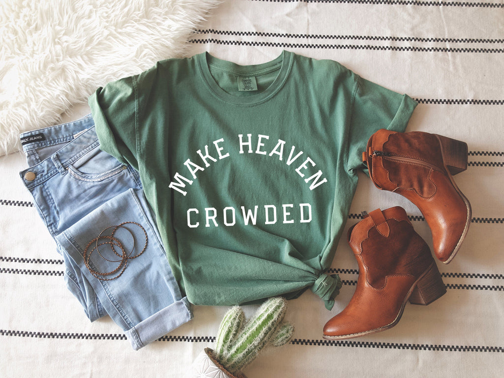 Green T-shirt with “Make Heaven Crowded” graphic on front
