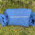 Blue sweatshirt back with embroidered text: Make Heaven Crowded