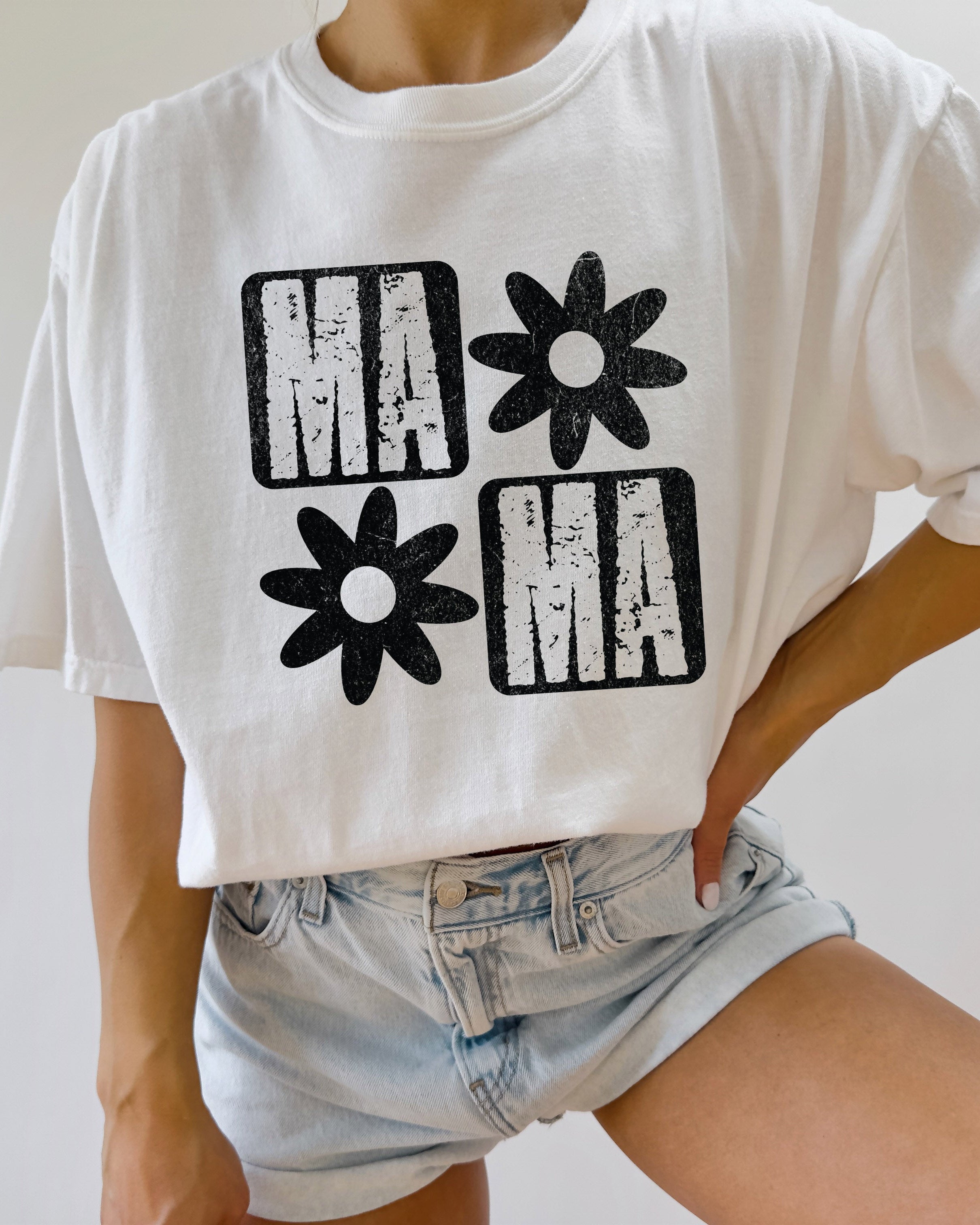 White short-sleeve T-shirt with black "MA" and flower graphic front
