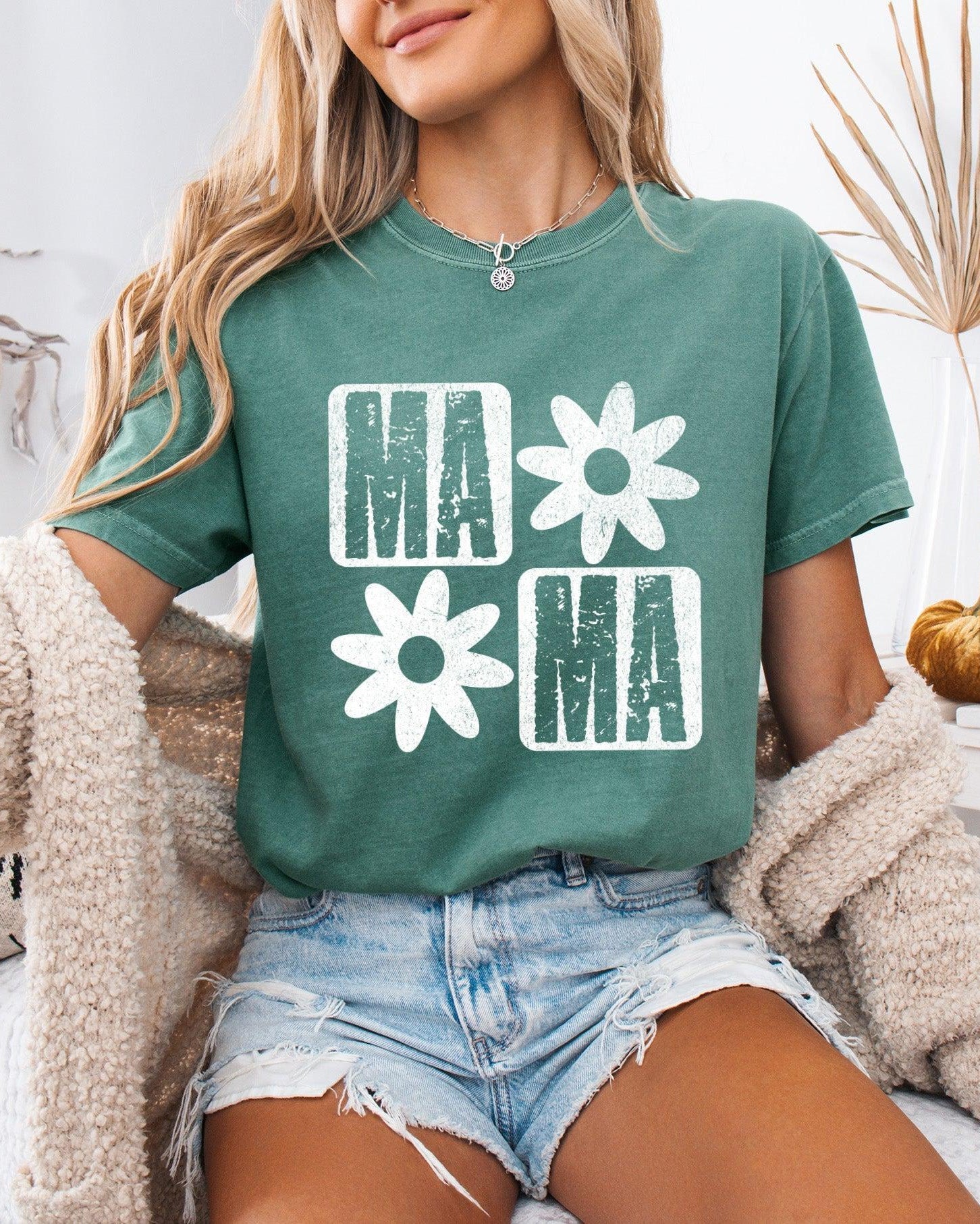 Green garment-dyed t-shirt with white flower and MA graphic, crew neck
