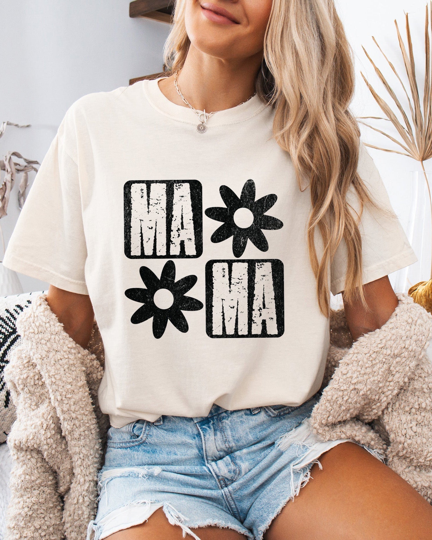 Ivory short-sleeve T-shirt with black "MA" and flower graphic front