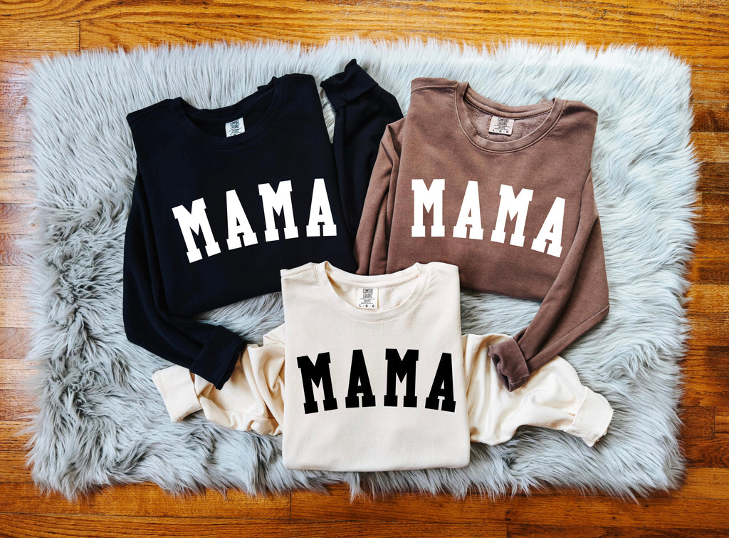 Set of unisex crewneck sweatshirts with front print reading "MAMA" in black, brown, and cream