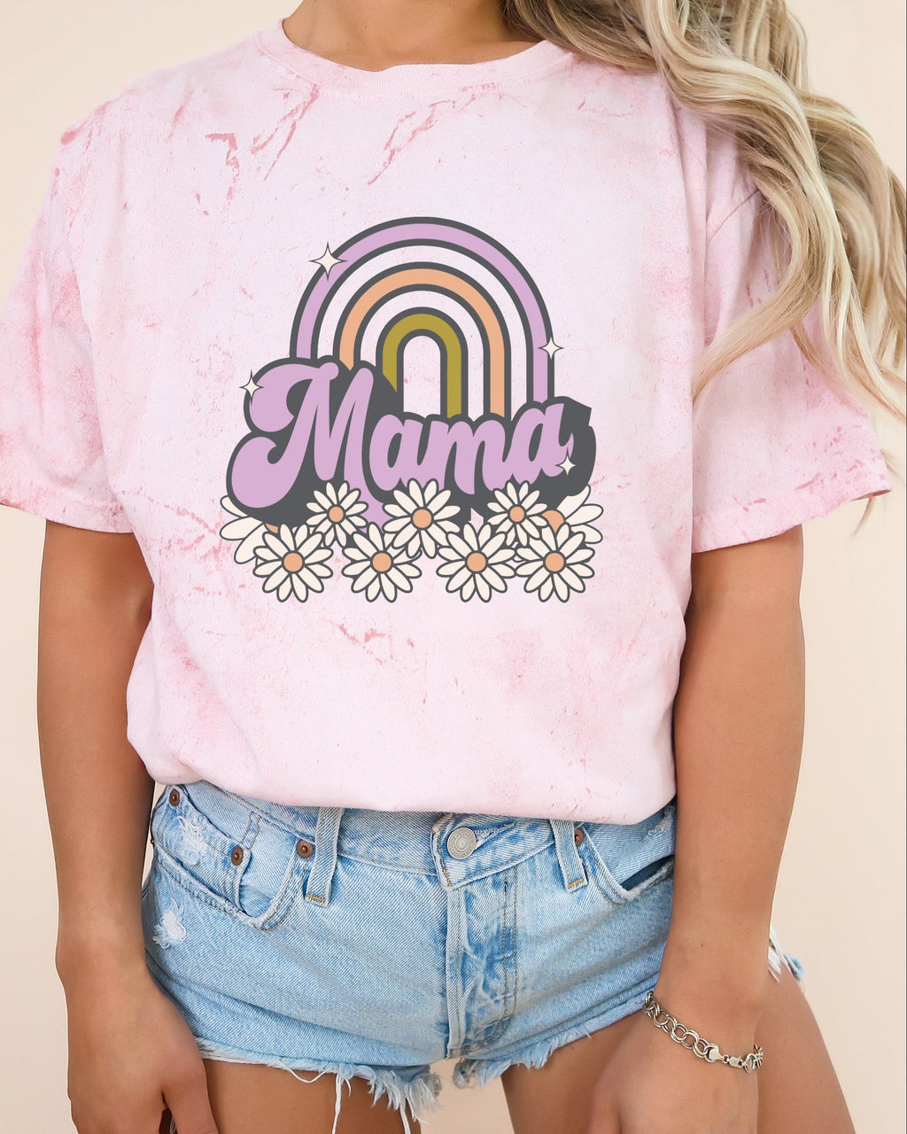 Light pink Mama rainbow graphic comfort t-shirt with white daisy flowers on front