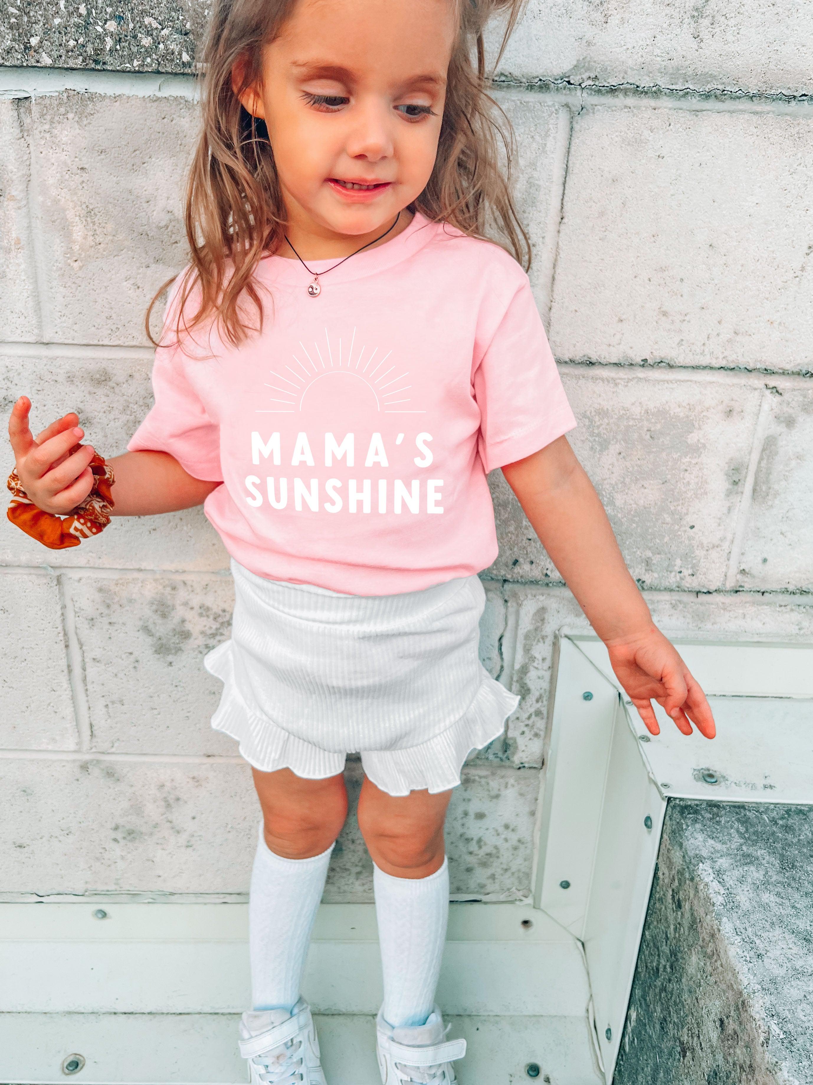 Light pink baby T-shirt with “Mama’s Sunshine” sun graphic