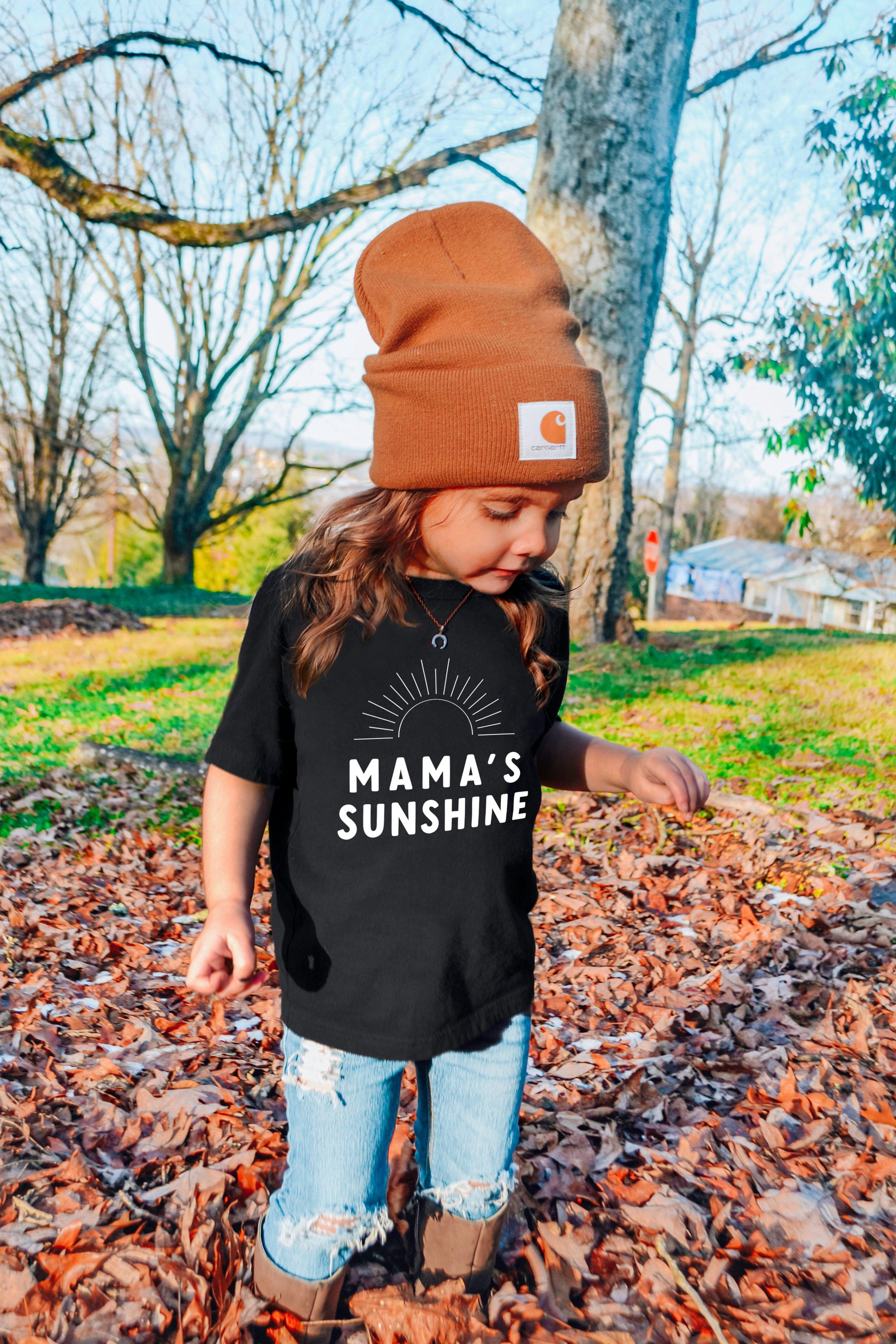 Black baby T-shirt with “Mama’s Sunshine” sun and rays logo print