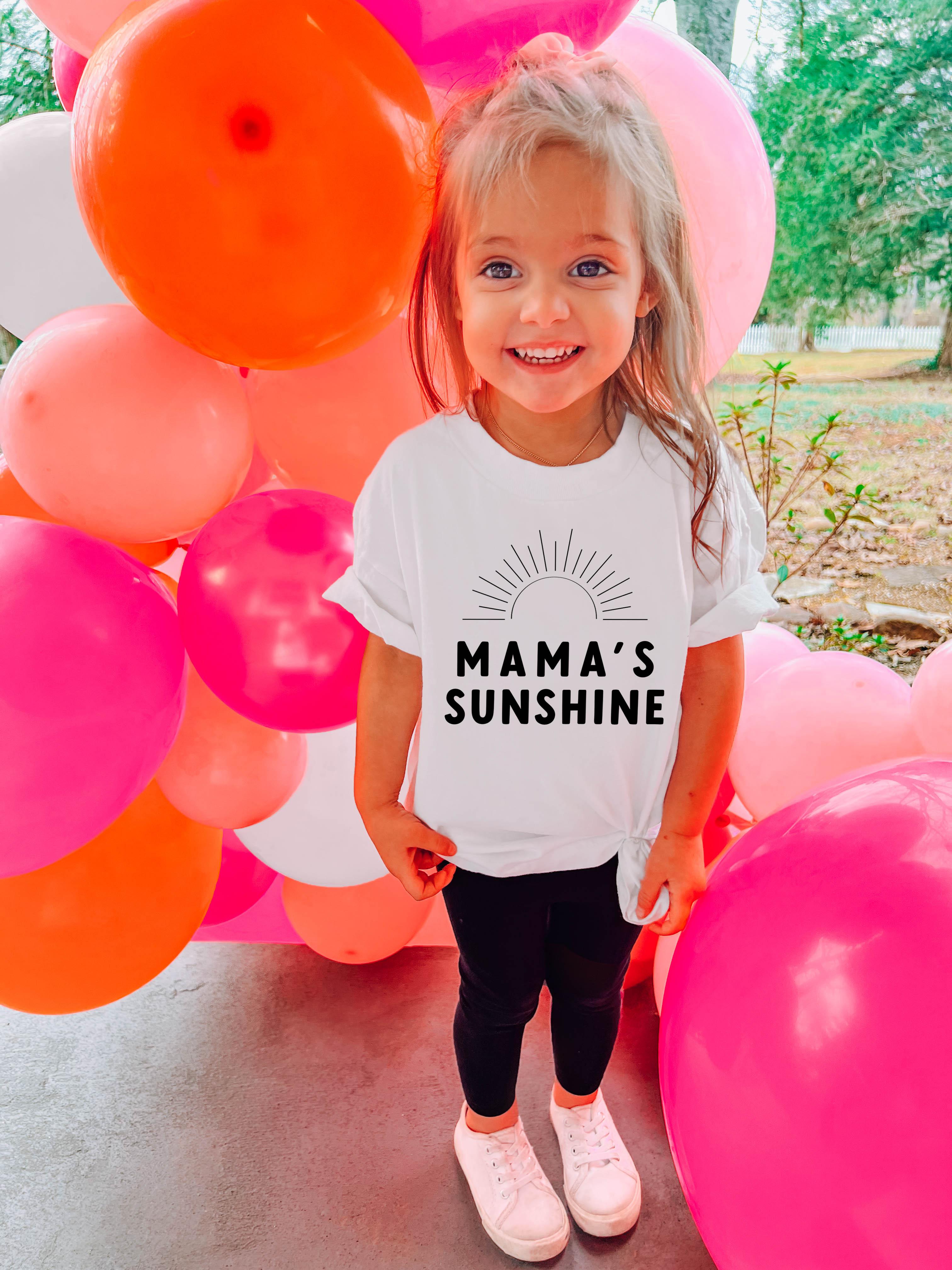 White toddler T-shirt with “Mama’s Sunshine” sun graphic and text