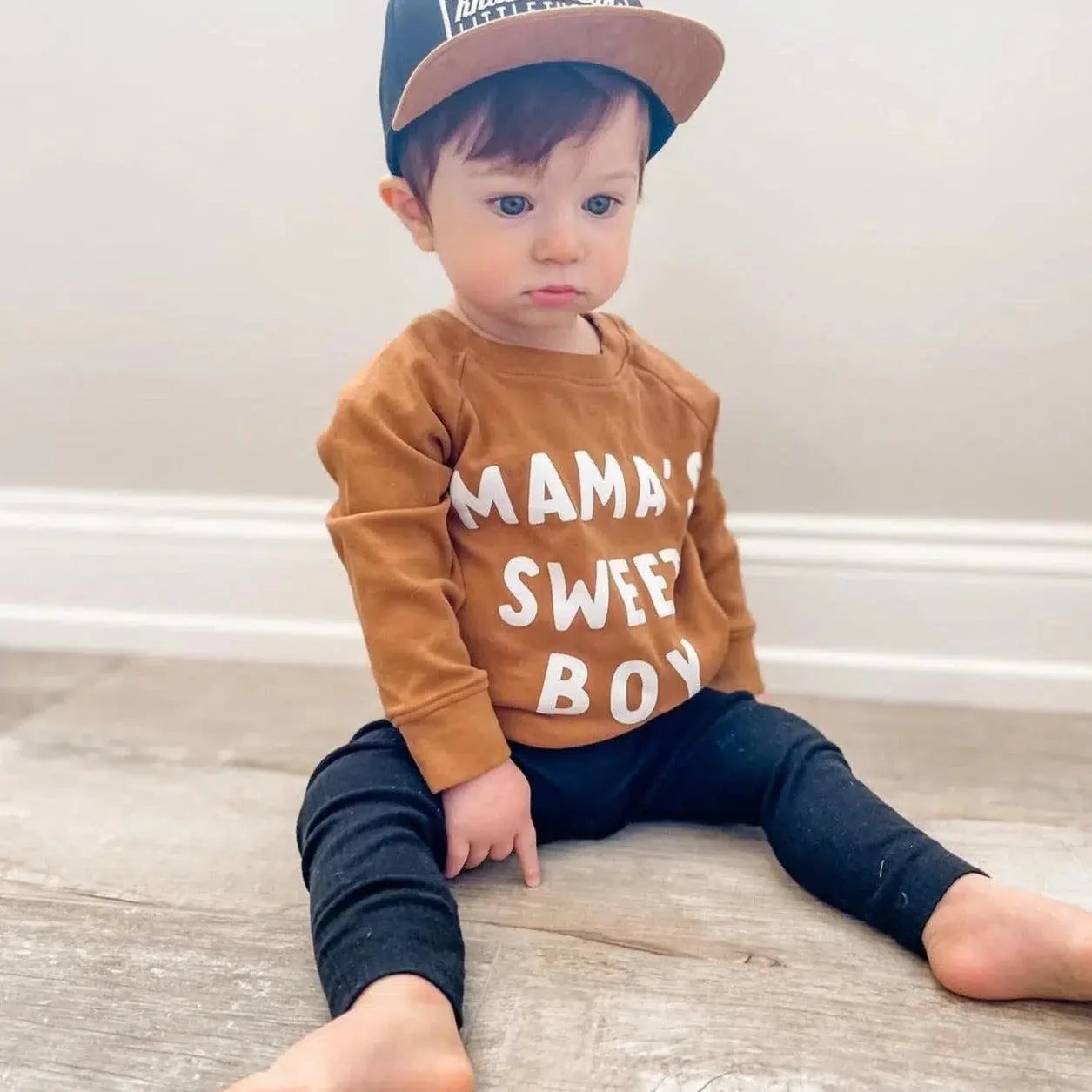 Baby pullover in ginger brown with white “MAMA’S SWEET BOY” text on front.