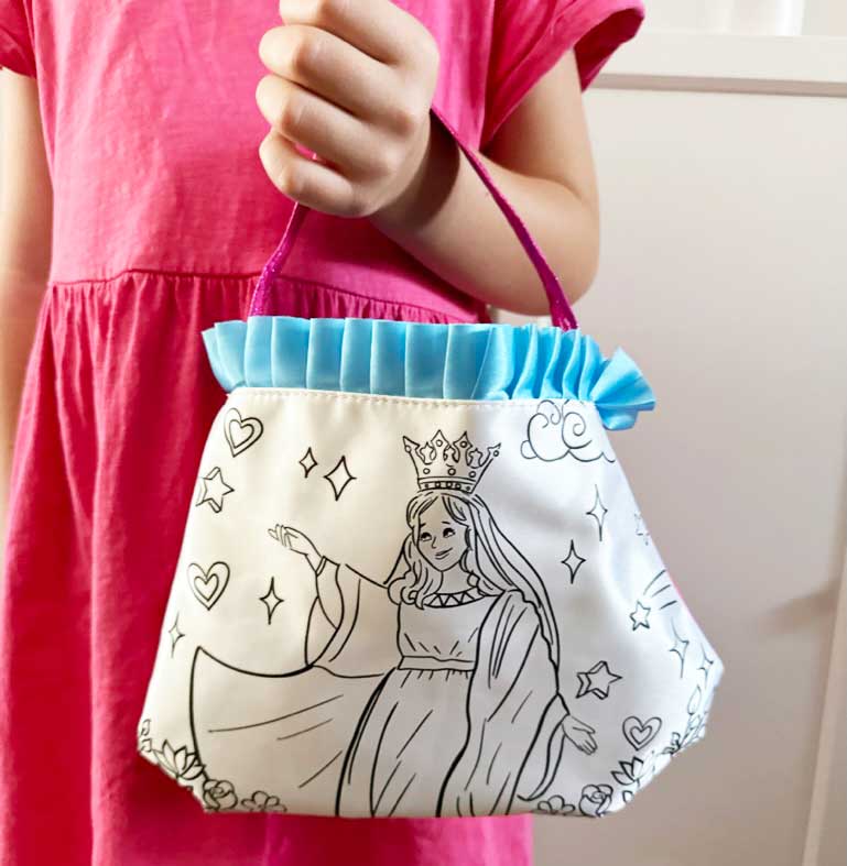 Mary color and pray purse with blue ruffled top and crown-and-stars design