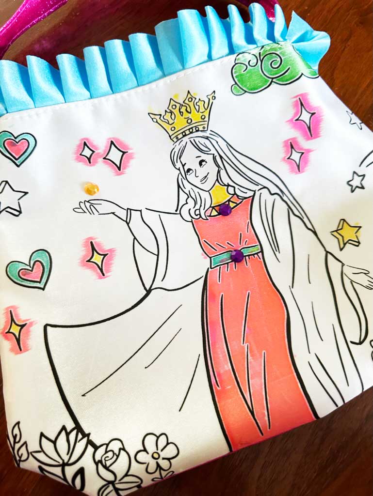 Color and pray purse with Mary artwork and colorful accents, blue ruffle edging