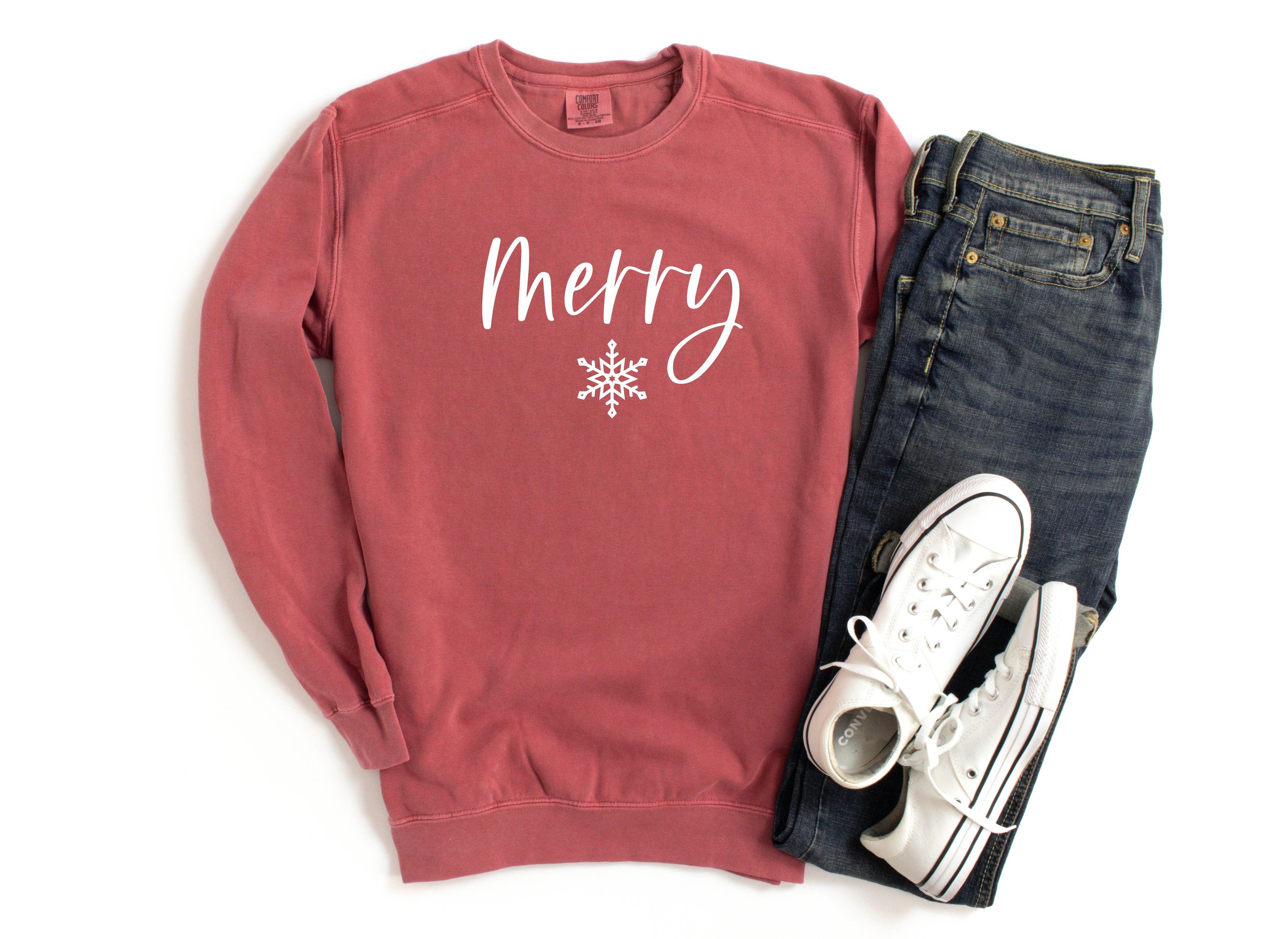 Crimson crewneck sweatshirt with 'Merry' snowflake graphic