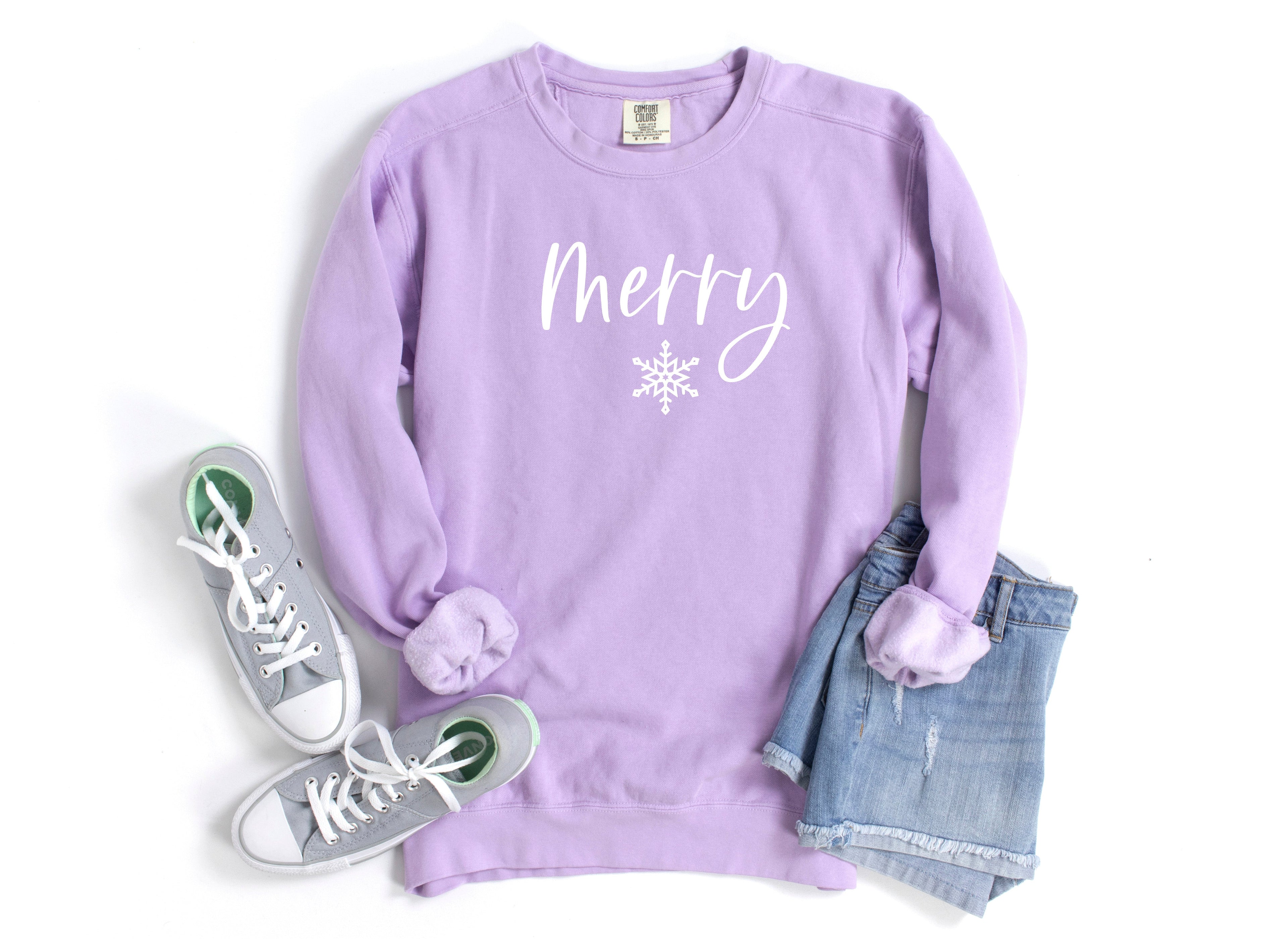 Lavender crewneck sweatshirt with 'Merry' snowflake graphic