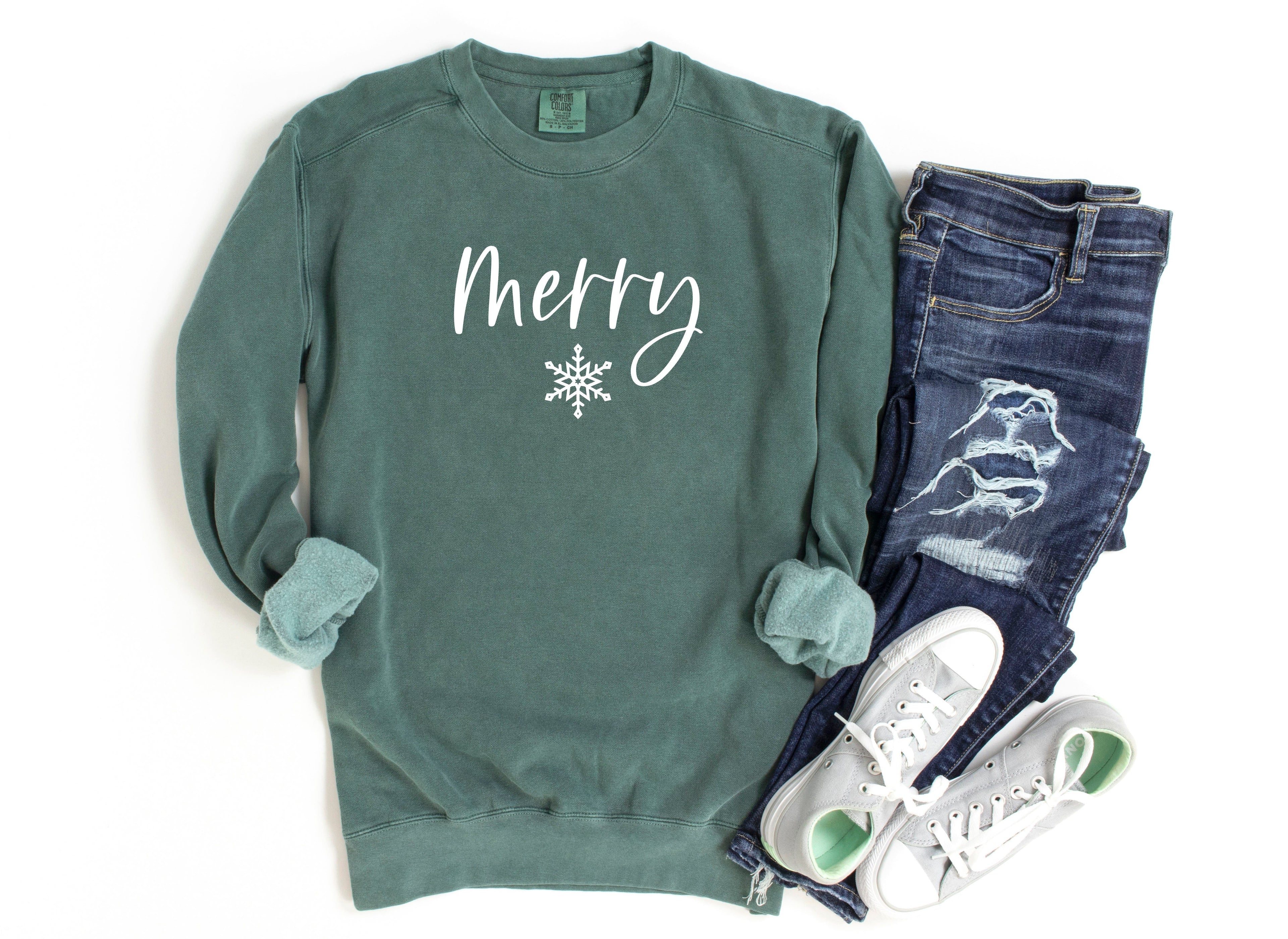 Forest green crewneck sweatshirt with 'Merry' snowflake graphic