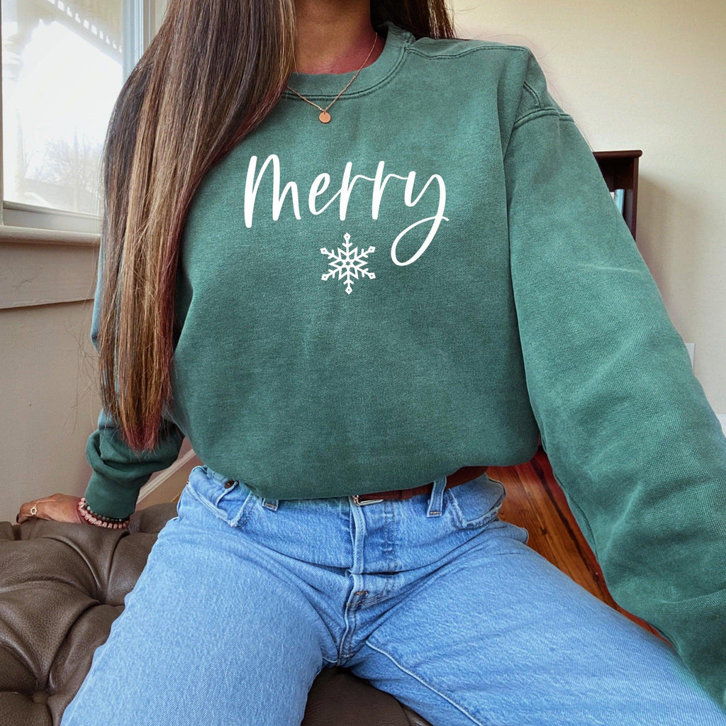 Teal crewneck sweatshirt with 'Merry' snowflake graphic