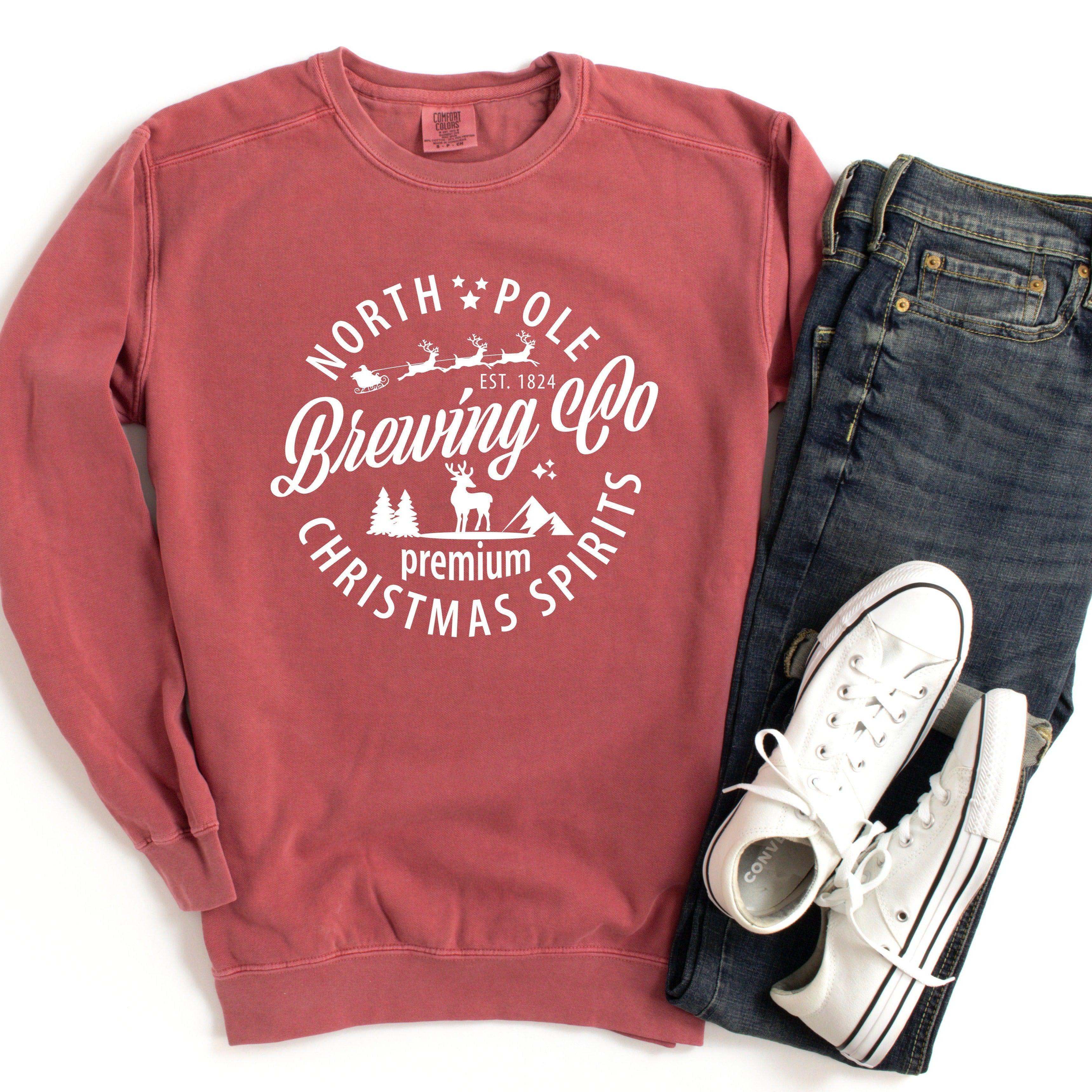 Rose crewneck sweatshirt with holiday logo graphic; ribbed cuffs and hem