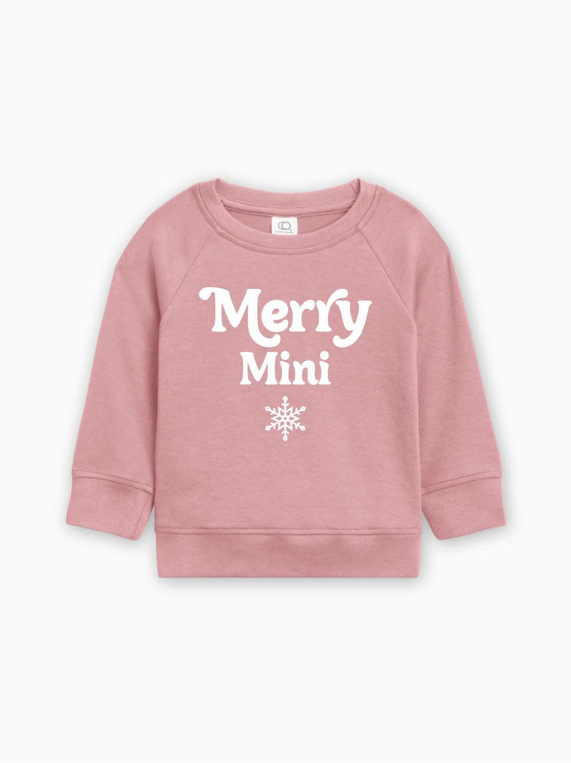 Light pink baby pullover sweatshirt with “Merry Mini” lettering and snowflake print