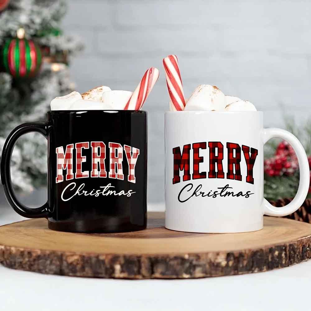 Two Christmas coffee mugs, black and white with red "Merry Christmas" print.