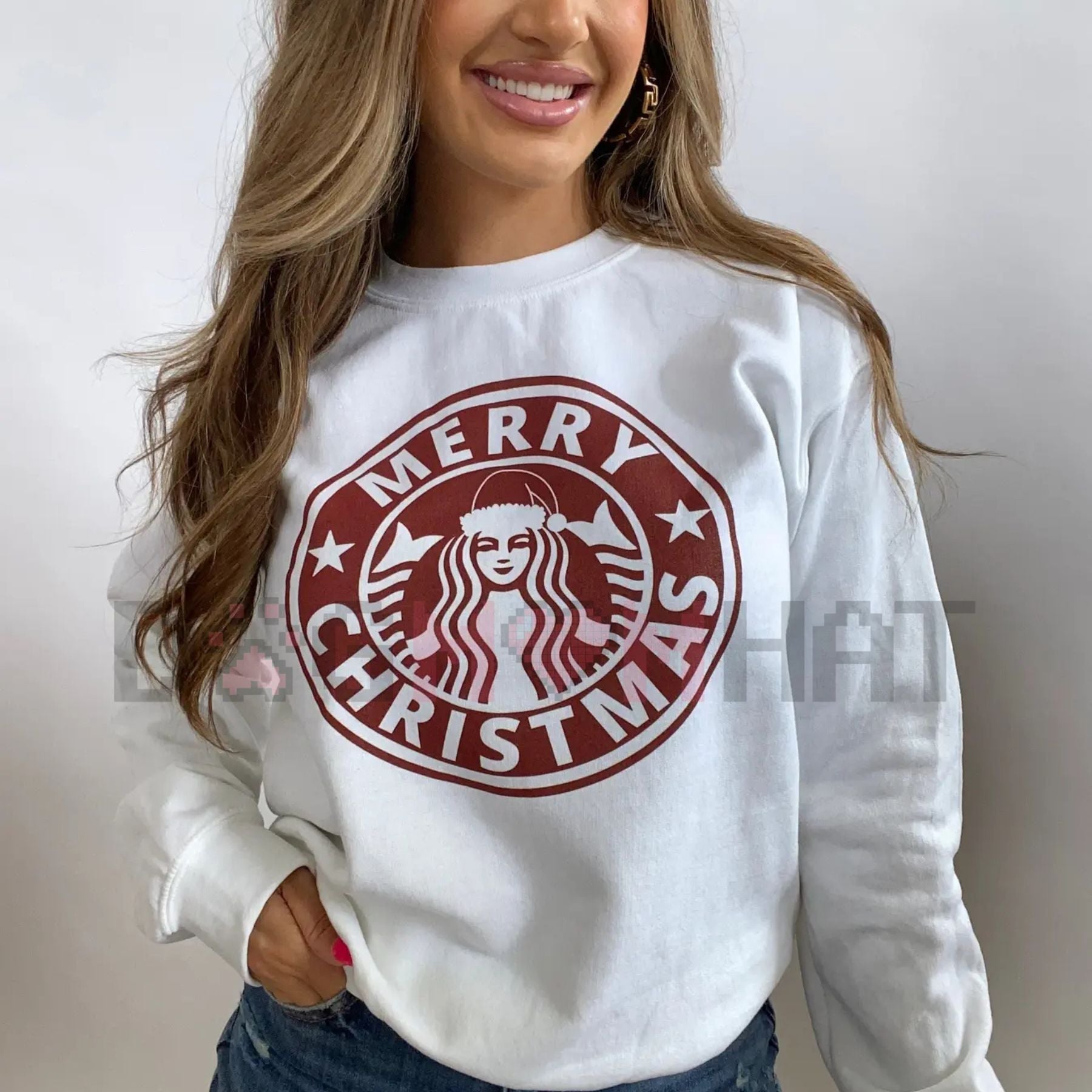 White crewneck sweatshirt with red “Merry Christmas” graphic emblem on front
