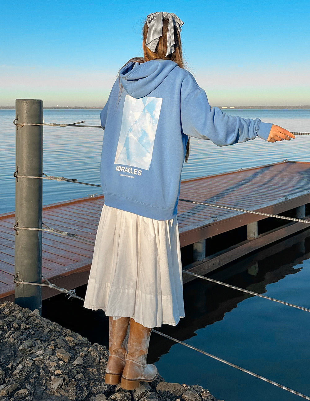 Unisex blue hoodie with hood, back graphic, and front pouch pocket