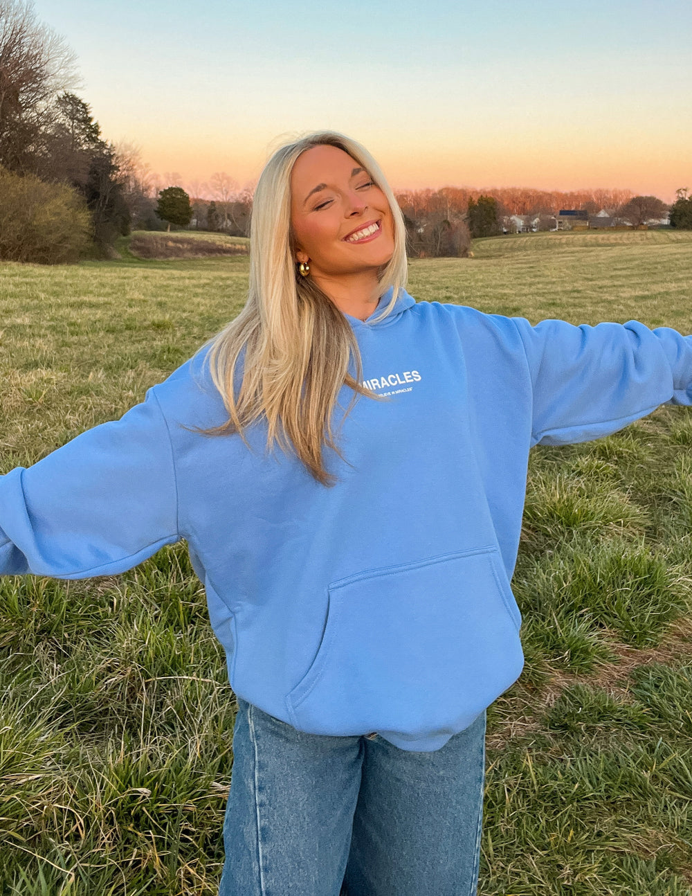 Light blue unisex hoodie with front pocket and small chest logo