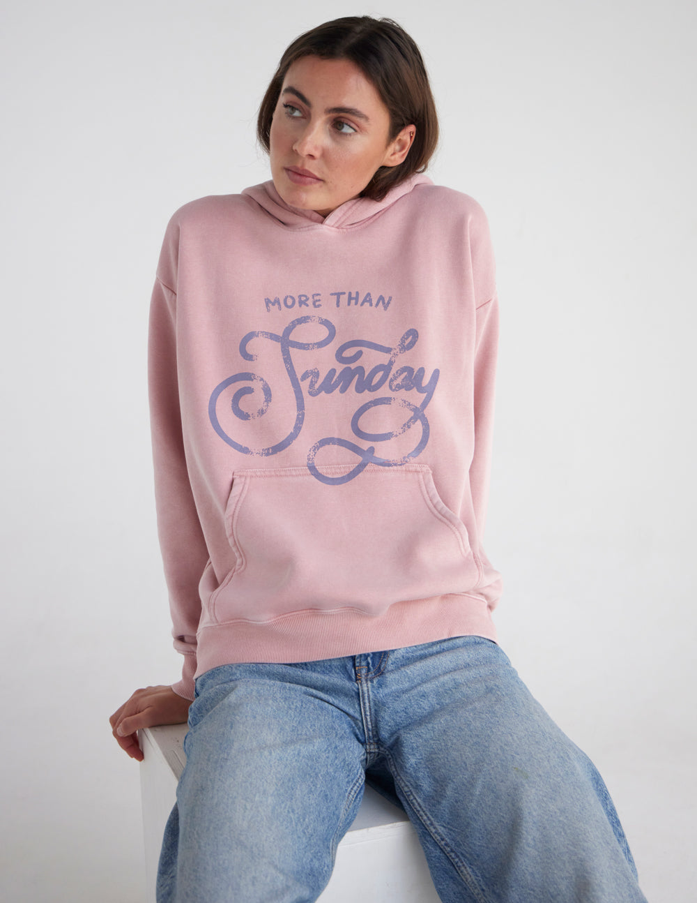 Unisex pink hoodie with hood and front logo graphic, front view