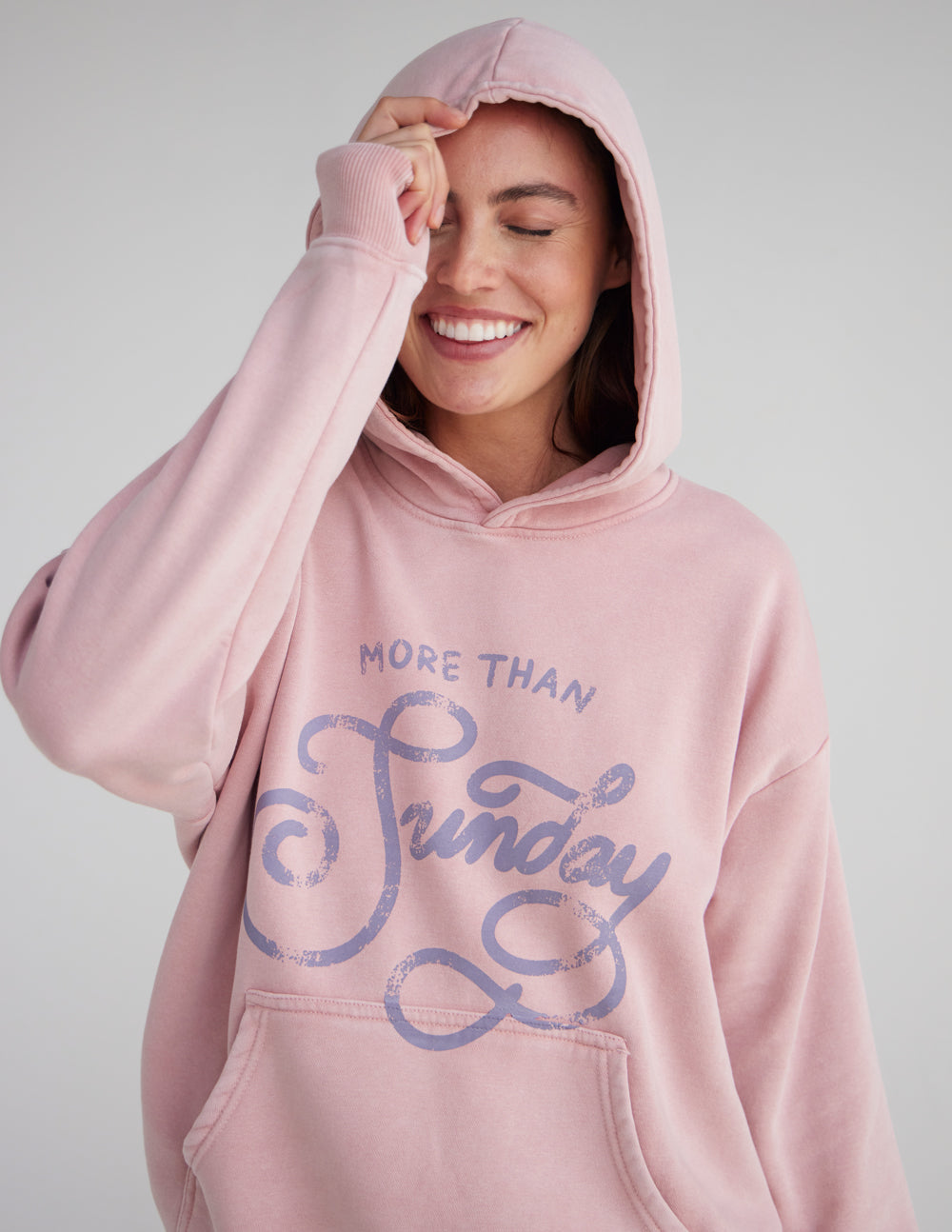 Unisex pink hoodie with hood up and front logo graphic, kangaroo pocket