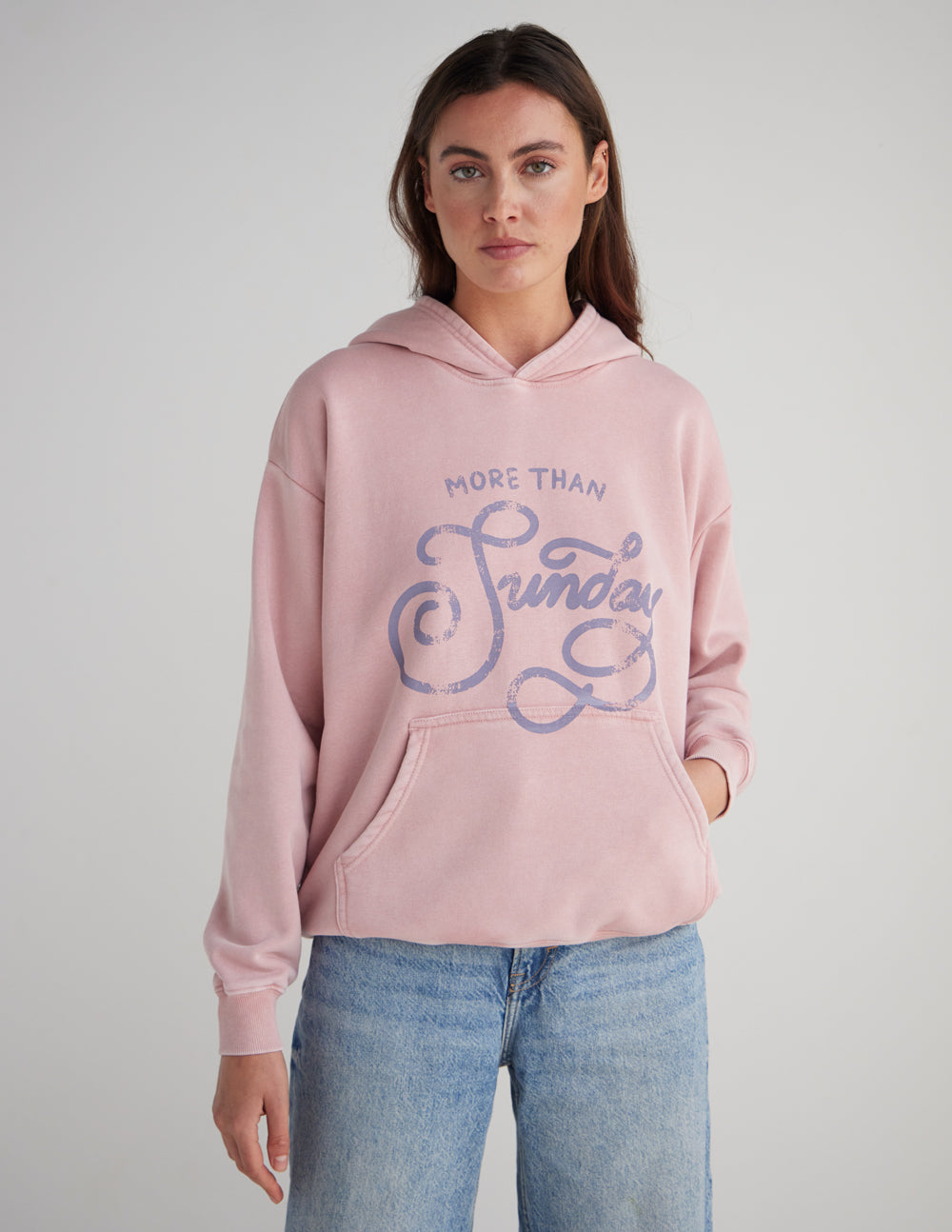 Unisex pink hoodie with hood and front graphic print, side front view