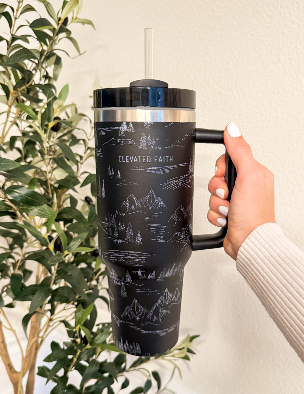 40 oz tumbler with black mountain pattern, metal rim, black lid and clear straw, gripped