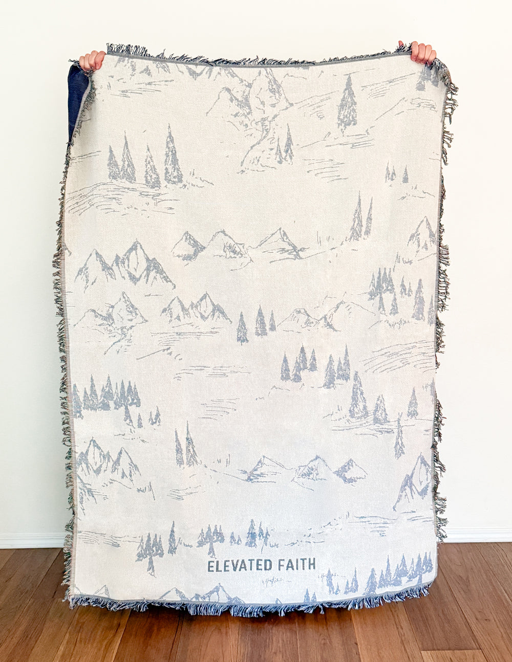Mountain print throw blanket, cream with blue scenery and fringed border
