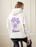 Light-cream unisex hoodie back view with purple flowers and Strength logo.