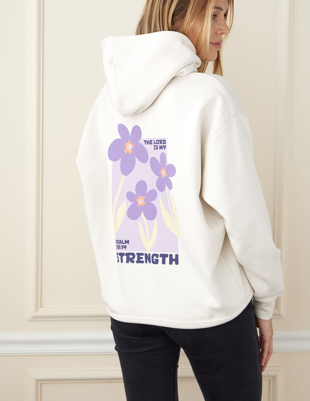 Light-cream unisex hoodie back with purple floral graphic and Strength text.