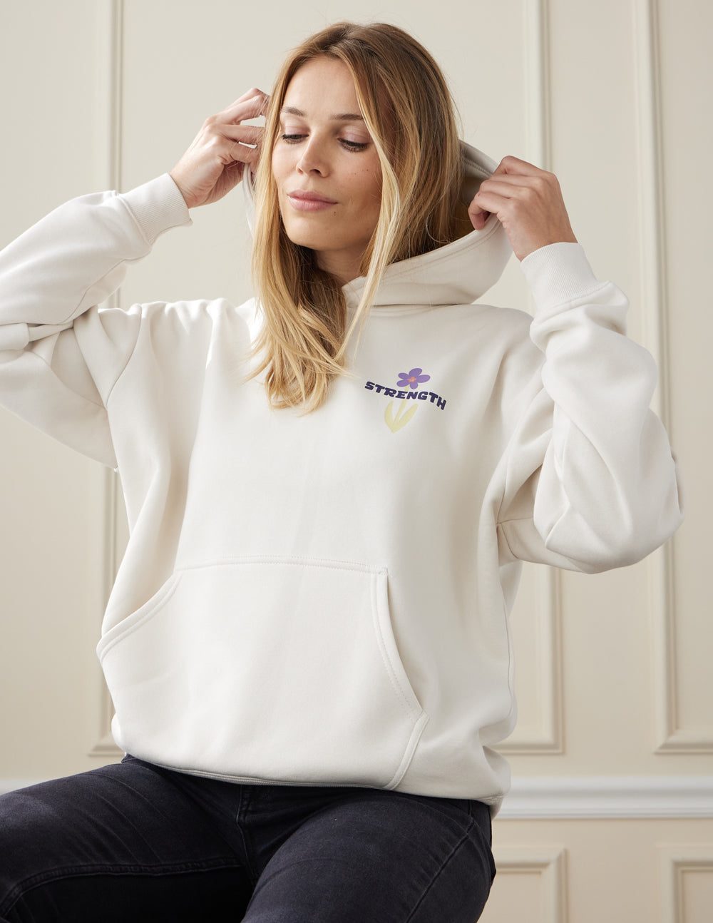 Light-cream unisex hoodie, front pocket, Strength logo on chest.