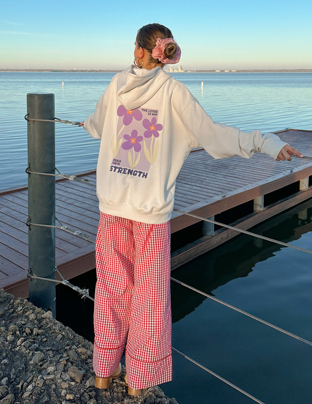 Light-cream unisex hoodie with large back floral print and Strength logo.