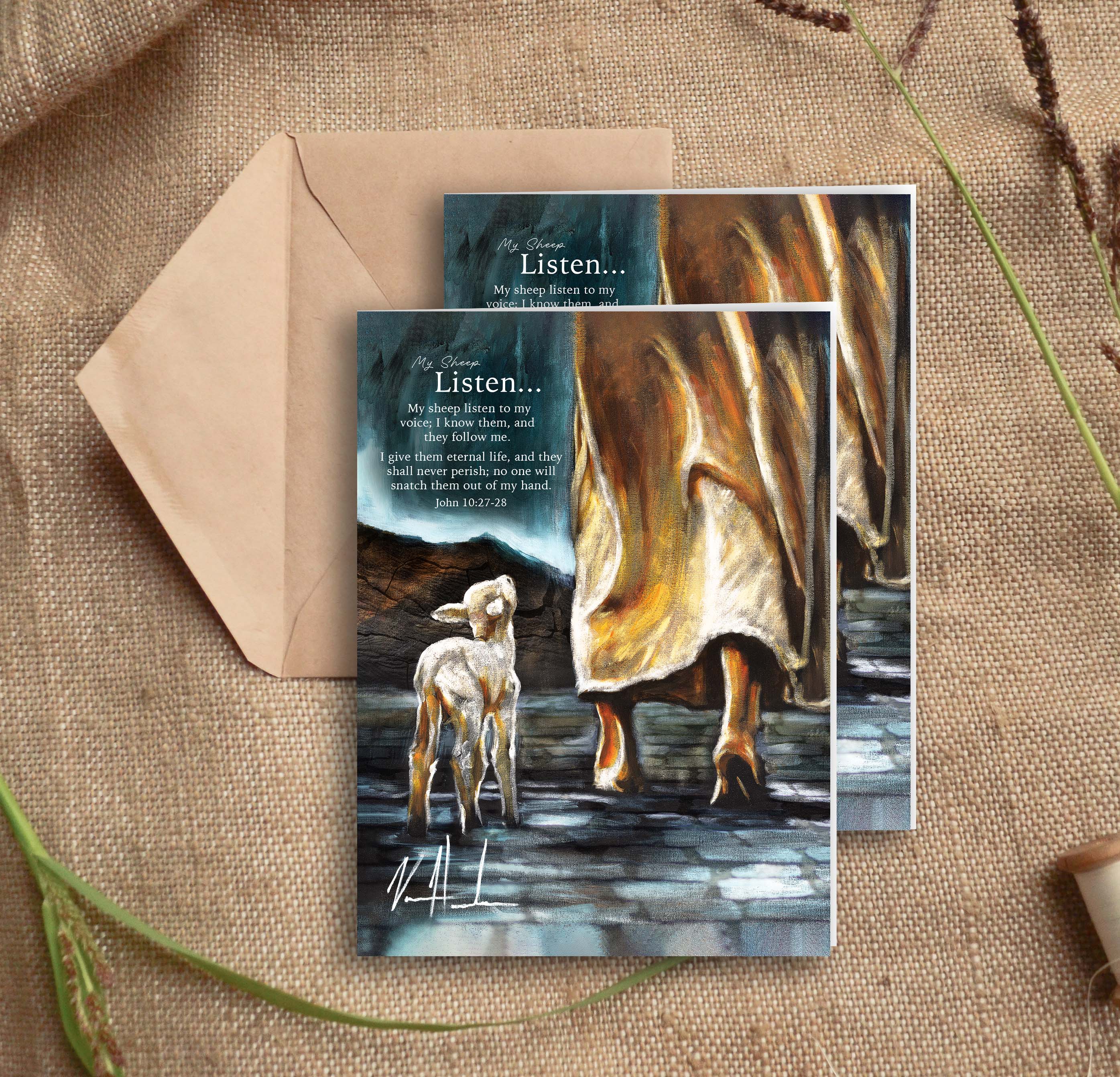 Greeting card front with kraft envelope and two cards on burlap fabric