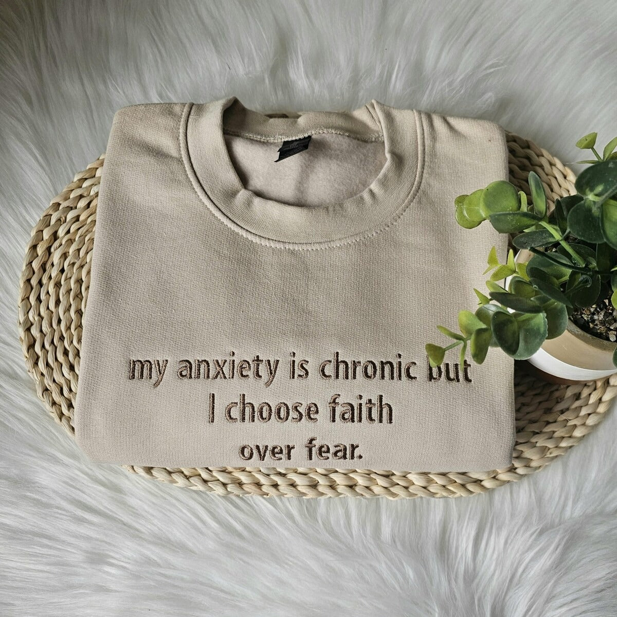 Beige crewneck sweatshirt with embroidered text on the chest: my anxiety is chronic