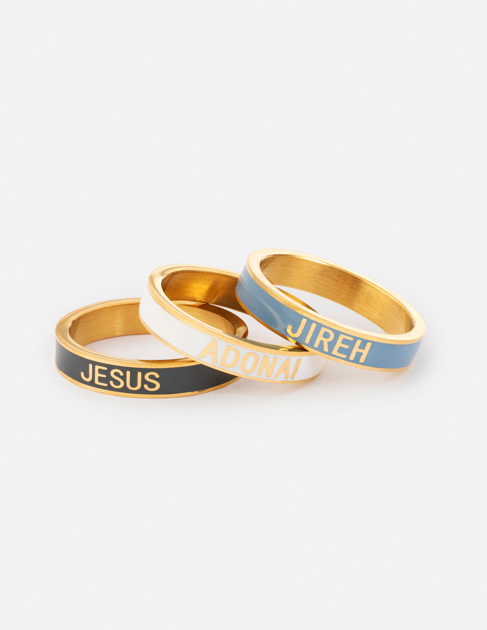Enamel ring set with three gold-tone bands: JESUS black, ADONAI light, JIREH blue.
