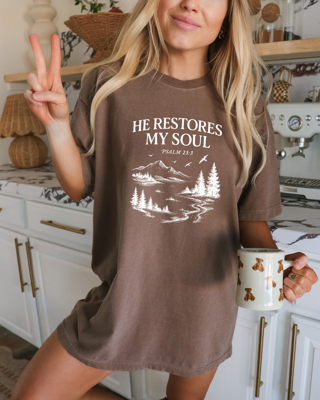 Brown unisex T-shirt with white “He Restores My Soul” mountain and tree graphic, crew neck