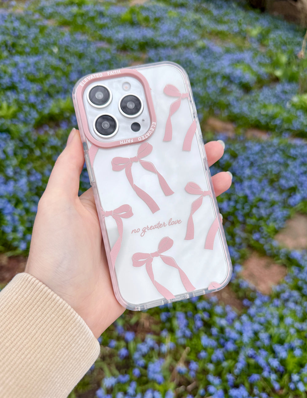 Phone case with pink bow-style silhouettes, clear sides, and camera cutouts