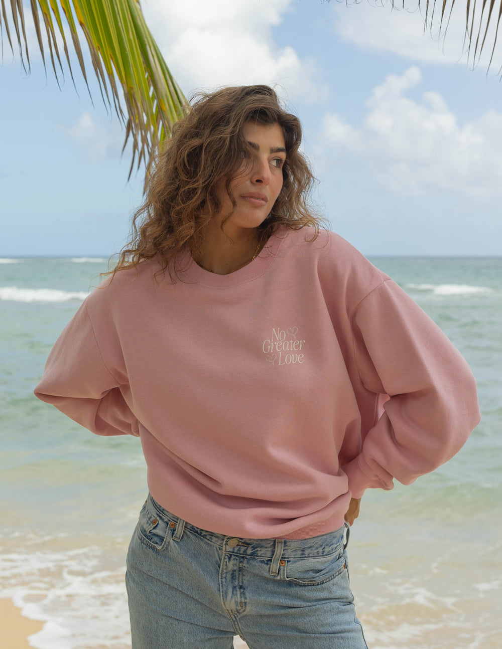 Pink unisex crewneck sweatshirt with small chest logo print, long sleeves and ribbed cuffs