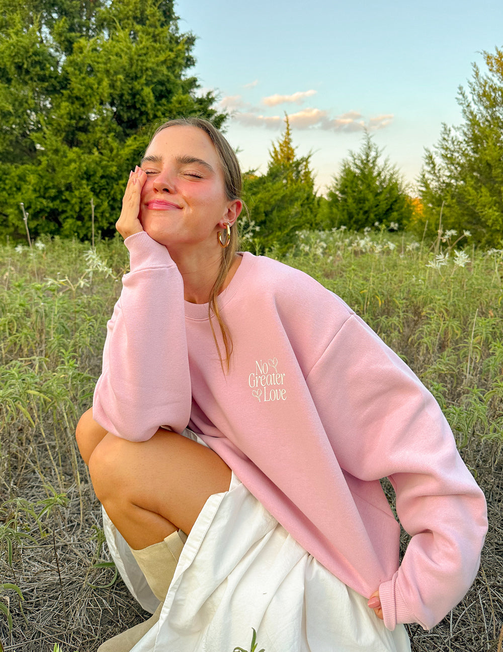 Pink sweatshirt with small chest logo print, long sleeves, ribbed collar and cuffs